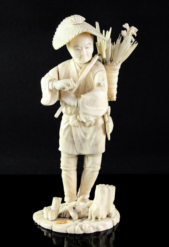 A Japanese sectional ivory figure of a flower seller, early 20th century, 26.5cm A/F